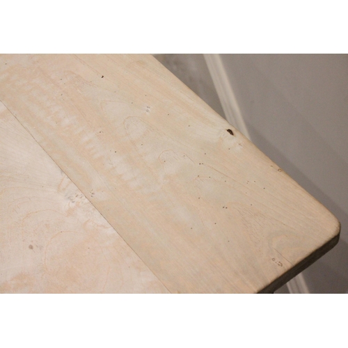 766 - A 19th century pine country kitchen table, the rectangular scrub top with rounded corners above a si... 