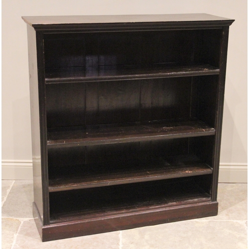 770 - A late 19th century stained wood open front bookcase, the moulded top above three adjustable shelves... 