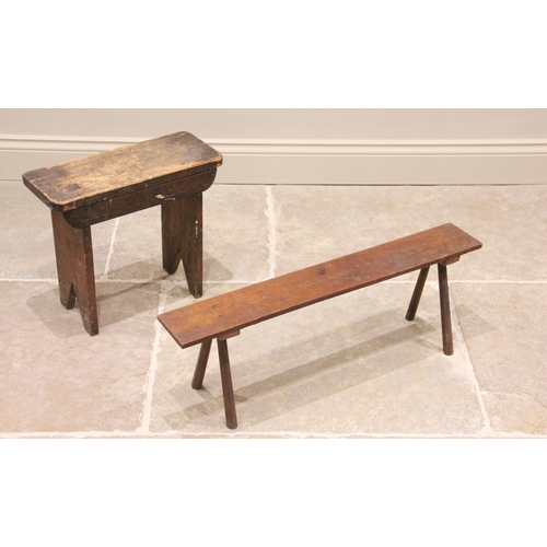 772 - A 19th century stained pine milking stool with a rectangular top on trestle type supports, 39cm high... 