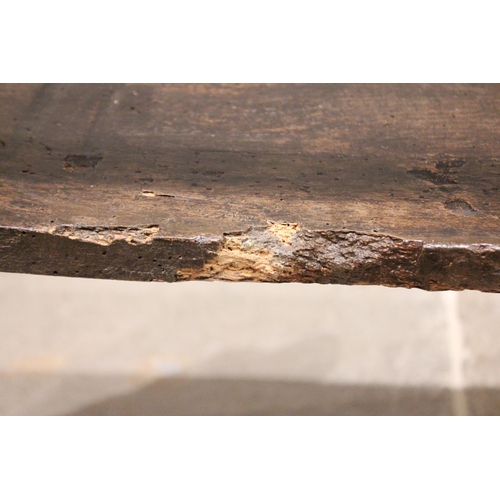 785 - A 19th century elm hall bench of cottage proportions, the shaped end supports united by a rail back ... 