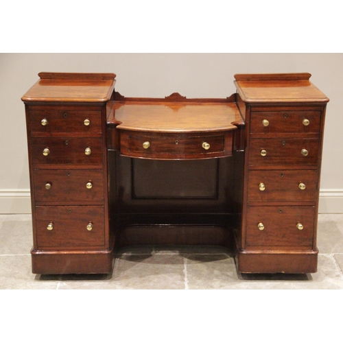 792 - A Victorian mahogany twin pedestal dressing table/writing desk, the 'dropped' bowfront centre with a... 