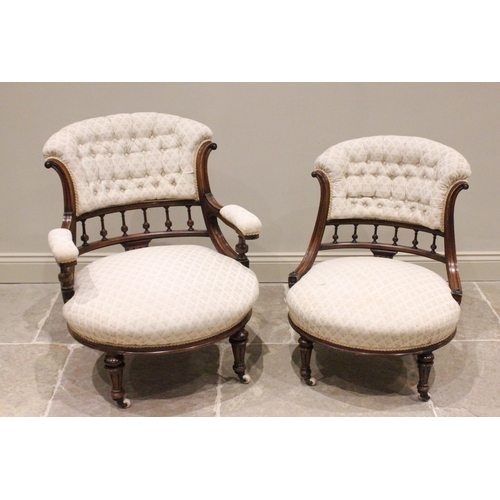 797 - A pair of Victorian ladies and gents walnut tub chairs, each with a padded button back above a spind... 