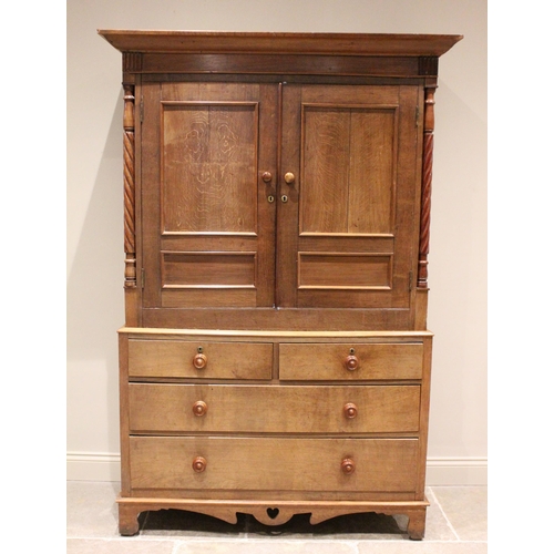 800 - A 19th century and later honey oak Welsh linen press, the cavetto cornice above a plain mahogany fri... 