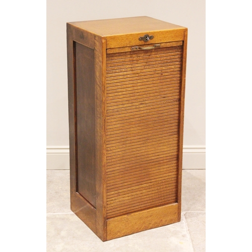 807 - An early 20th century tambour front oak filing cabinet, the tambour drop front opening to nine slidi... 