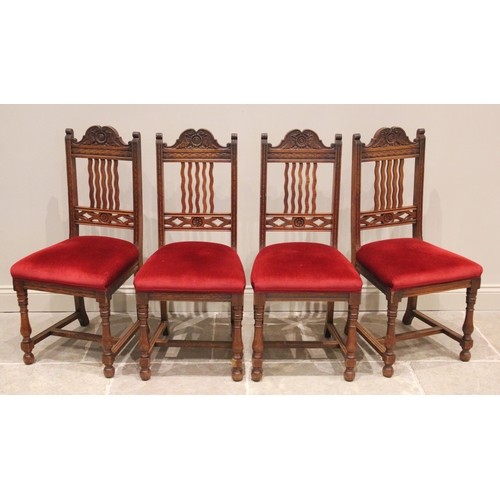 808 - A set of four early 20th century oak dining chairs, each with a carved crest rail above a wavy lath ... 