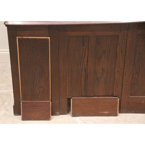 809 - An early 20th century oak roll top desk, the tambour front opening to an arrangement of small drawer... 