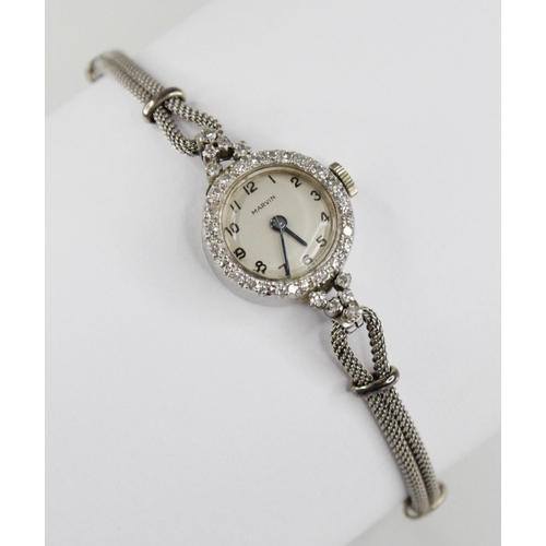 81 - A ladies vintage Marvin platinum diamond set cocktail watch, circular dial with Arabic numerals, sin... 