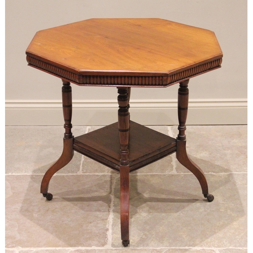 811 - An Edwardian walnut octagonal library table, the top with a lobed frieze raised upon four turned upr... 