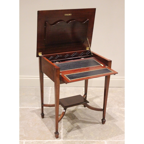 819 - An Edwardian mahogany folding writing table, the rectangular top hinged to reveal a compartmentalise... 