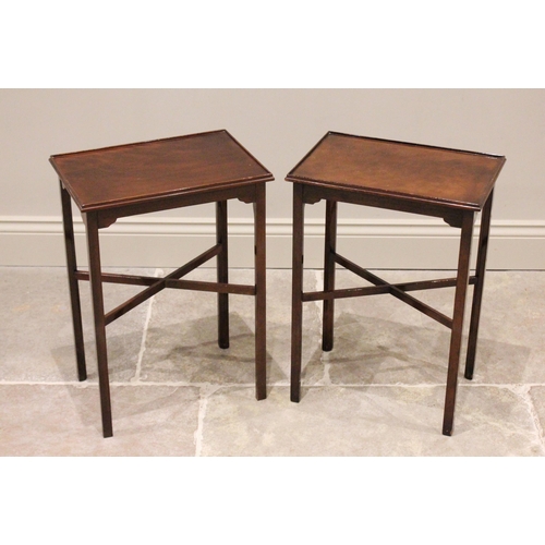 826 - A pair of mahogany lamp tables, 20th century, the rectangular table tops with a raised rim, upon cha... 