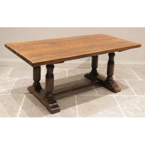 828 - An elm refectory table, late 20th century, the rectangular slab top raised upon two pairs of substan... 