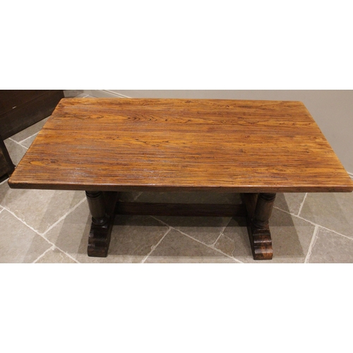 828 - An elm refectory table, late 20th century, the rectangular slab top raised upon two pairs of substan... 