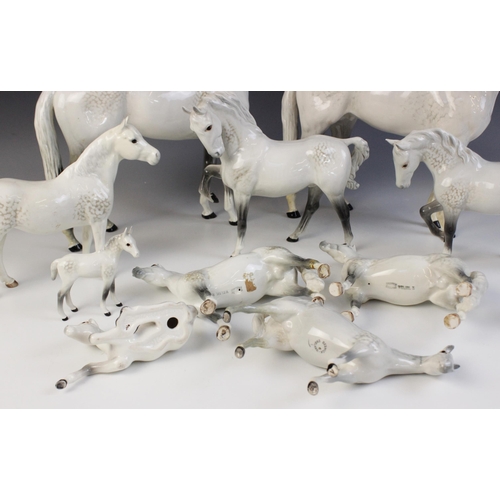 560 - A selection of Beswick Grey horses, to include a Horse, Head Tucked, Leg Up, model No. 1549, first v... 