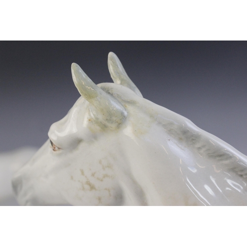 560 - A selection of Beswick Grey horses, to include a Horse, Head Tucked, Leg Up, model No. 1549, first v... 