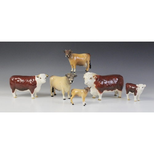 563 - Two Beswick cattle families, comprising: a Jersey Bull, model No. 1422 in gloss, 