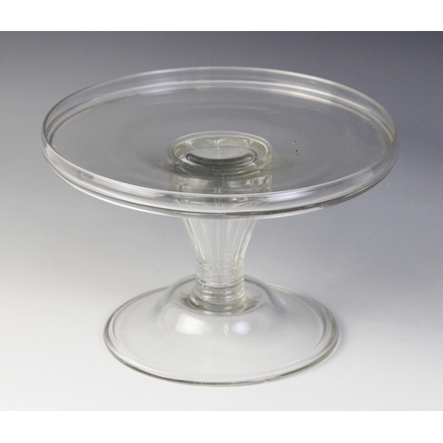 579 - A glass tazza, late 18th century, the flat galleried top raised on a reeded lobed hollow stem of inv... 