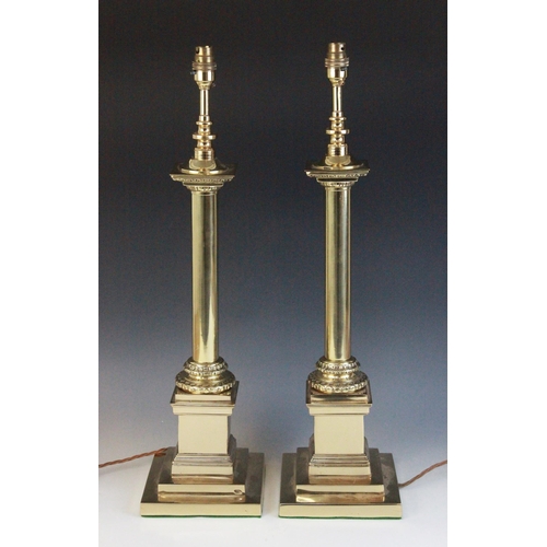 604 - A pair of brass Corinthian column table lamps, each cast with a plain column upon a wreath collar an... 