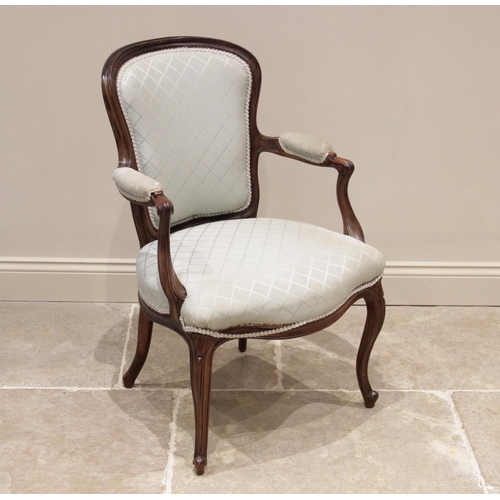 704 - A Louis XV walnut fauteuil, late 19th/early 20th century, the padded back rest extending to out swep... 