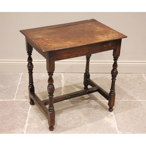 705 - An 18th century and later oak side table, the rectangular top above a plain frieze, raised upon balu... 