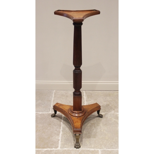 748 - A 19th century mahogany torchere, the triform top with a raised moulded rim upon a wrythen an reeded... 