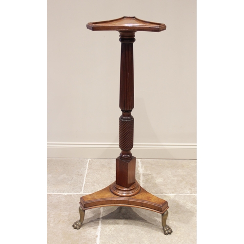 748 - A 19th century mahogany torchere, the triform top with a raised moulded rim upon a wrythen an reeded... 