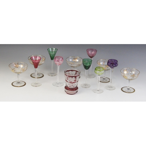 586 - A cut glass beaker, the body with flashed cranberry bands, the top band wheel cut with a continuous ... 