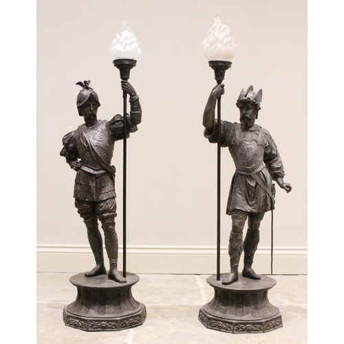 603 - A pair of late 19th century bronzed spelter figural floor standing lamps, each modelled as a conquis... 