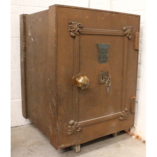 637 - A late 19th century cast iron floor standing safe, with cast shell decoration and label for ‘Millner... 