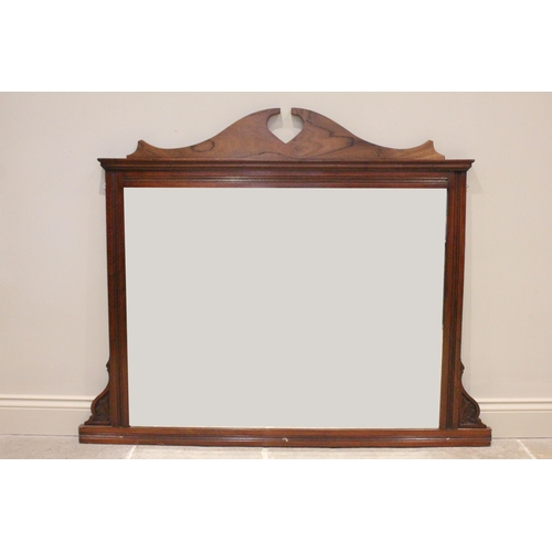 680 - A late Victorian walnut over mantle mirror, the rectangular bevelled mirrored plate within a channel... 