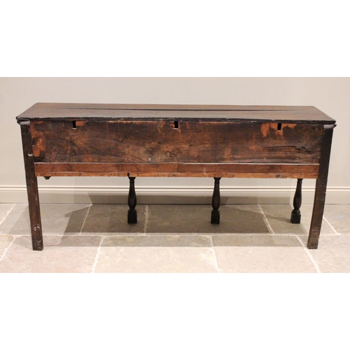 706 - An early 18th century oak dresser base, the three plank moulded top above three lip moulded frieze d... 