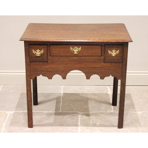 737 - A George III oak lowboy, the rectangular moulded top above three oak lined and lip moulded drawers a... 