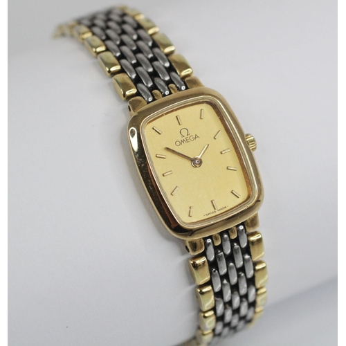 78 - A Lady's Omega De Ville stainless steel quartz wristwatch, the gold toned rectangular dial with bato... 