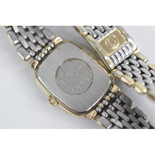 78 - A Lady's Omega De Ville stainless steel quartz wristwatch, the gold toned rectangular dial with bato... 