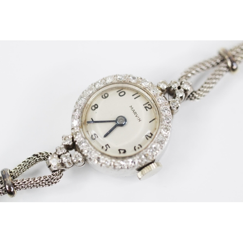 81 - A ladies vintage Marvin platinum diamond set cocktail watch, circular dial with Arabic numerals, sin... 