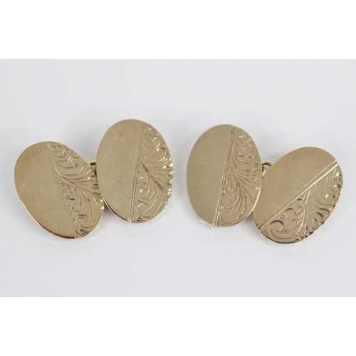 118 - A pair of 9ct gold cufflinks, each oval form panel with foliate decoration, 18mm x 13mm, marks for B... 