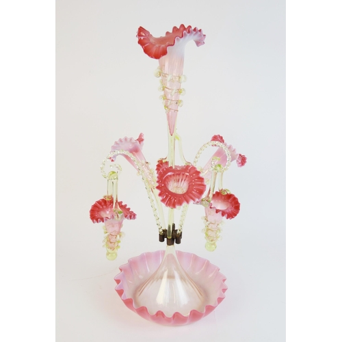 595 - A Victorian style pink and vaseline glass epergne, the central frilled trumpet shaped vase applied w... 