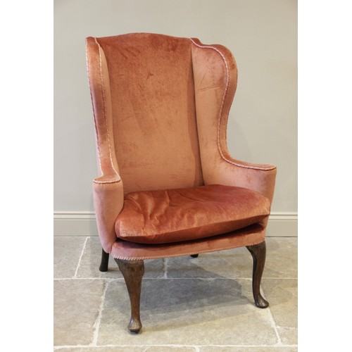 729 - A George III wing back fireside armchair, later re-covered in pink velour with applied rope detail, ... 