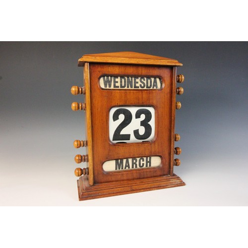 628 - An early 20th century walnut cased perpetual roller desk calendar, of architectural form, the roller... 