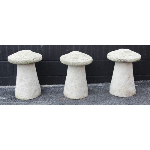 829 - A trio of reconstituted stone staddle stones, each of typical mushroom form, 58cm high (3)