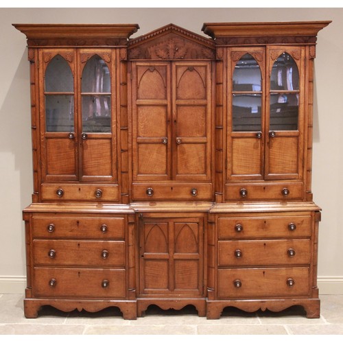 783 - A mid 19th century inverted breakfront oak housekeepers cupboard, the central architectural pediment... 