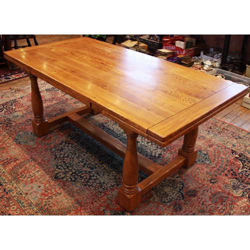 820 - An oak draw leaf refectory table by Willis and Gambier, late 20th century, the cleated slab top with... 