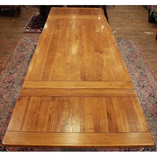 820 - An oak draw leaf refectory table by Willis and Gambier, late 20th century, the cleated slab top with... 