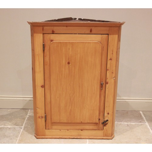 763 - A Victorian pine straight front hanging corner cupboard, the single door opening to two shelves, 102... 