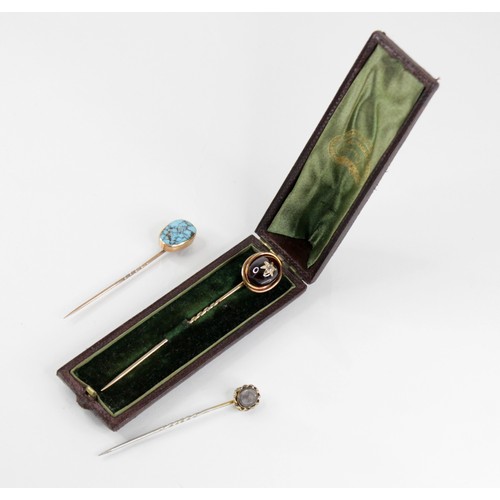 117A - A Victorian garnet and diamond set stick pin, the central garnet carbuncle surmounted by a rose cut ... 