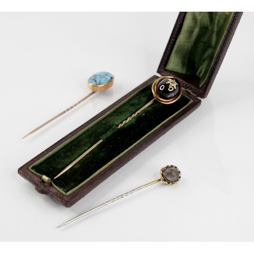 117A - A Victorian garnet and diamond set stick pin, the central garnet carbuncle surmounted by a rose cut ... 