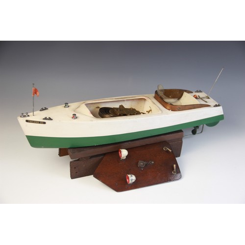 670 - A Tri-Ang clockwork speed boat, early 20th century circa 1930, the wooden hull painted in green and ... 