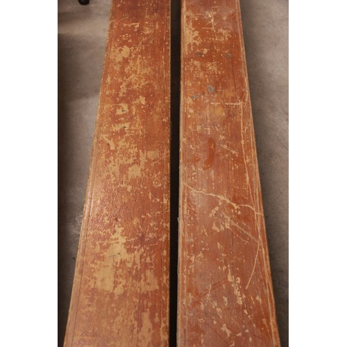 822 - A pair of mid century stained wooden school gym benches, each raised on three trestle type supports,... 