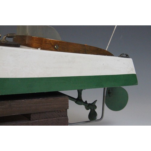 670 - A Tri-Ang clockwork speed boat, early 20th century circa 1930, the wooden hull painted in green and ... 