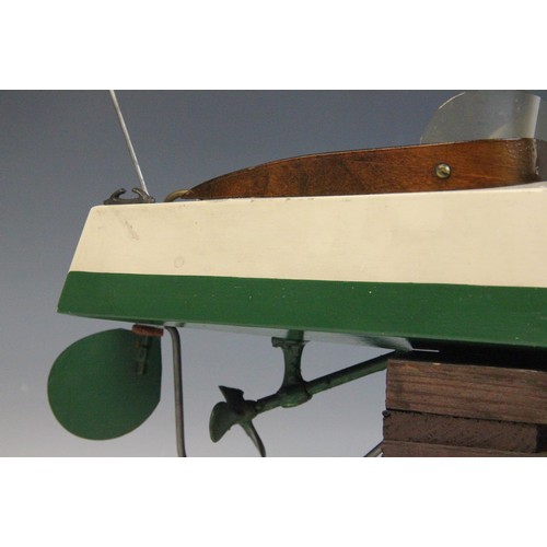 670 - A Tri-Ang clockwork speed boat, early 20th century circa 1930, the wooden hull painted in green and ... 