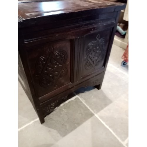 714 - A large 18th century carved oak coffer, with a four panel hinged cover, the two central panels carve... 